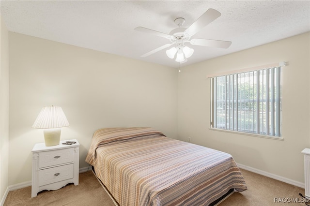 bedroom with ceiling fan, light colored carpet, and radiator heating unit