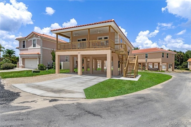 10200 W Waterlander Loop, Homosassa, FL 34448 - view of front of home with a carport, concrete driveway, stairs, a tile roof, and stucco siding