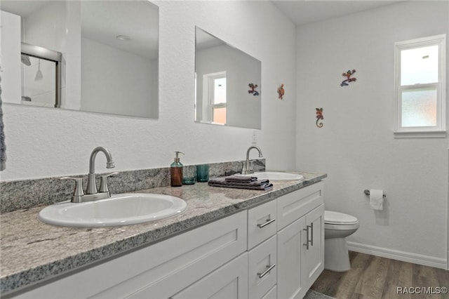 10200 W Waterlander Loop, Homosassa, FL 34448 - full bath featuring double vanity, plenty of natural light, wood finished floors, and toilet