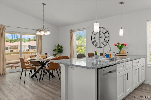 10200 W Waterlander Loop, Homosassa, FL 34448 - kitchen with dishwasher, vaulted ceiling, a sink, light wood-style floors, and white cabinets