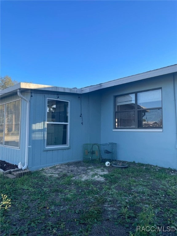 view of side of property with a yard