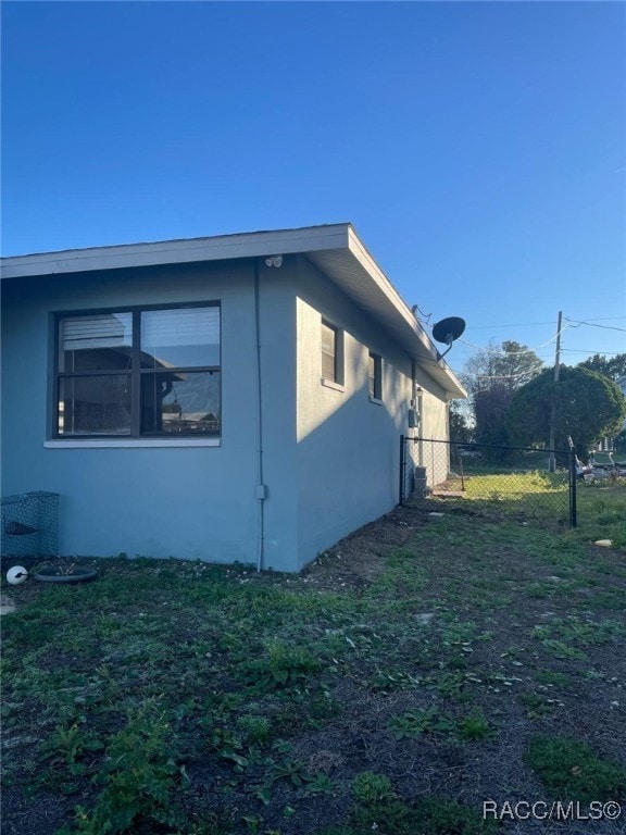 view of side of home with a yard