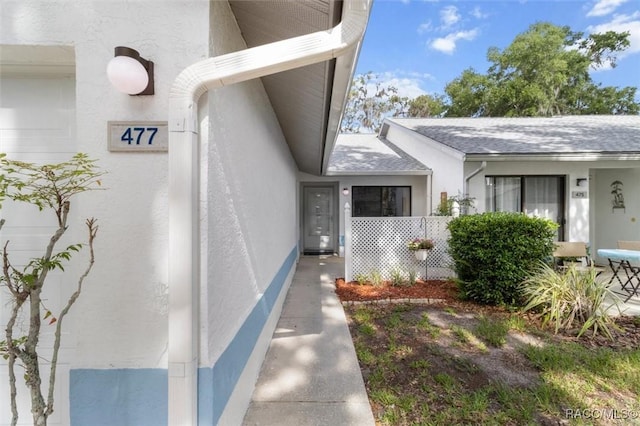 477 Siesta Ter, Inverness, FL 34450 - entrance to property with roof with shingles and stucco siding