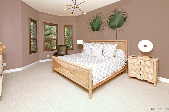 carpeted bedroom featuring an inviting chandelier