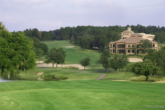 surrounding community with a yard and a water view