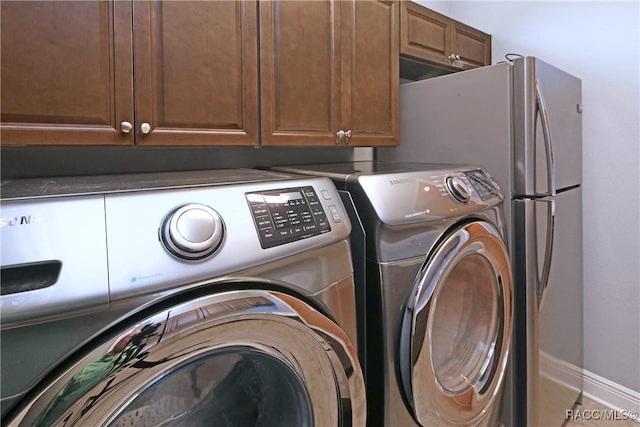 laundry room featuring washing machine and clothes dryer