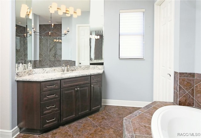 bathroom with tile patterned floors, vanity, and a bath