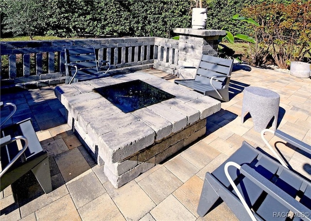 view of patio / terrace with an outdoor fire pit