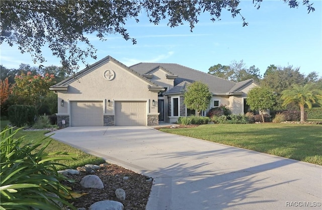 view of front of house with a garage and a front lawn