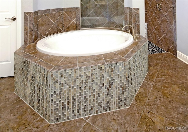 details featuring a relaxing tiled tub