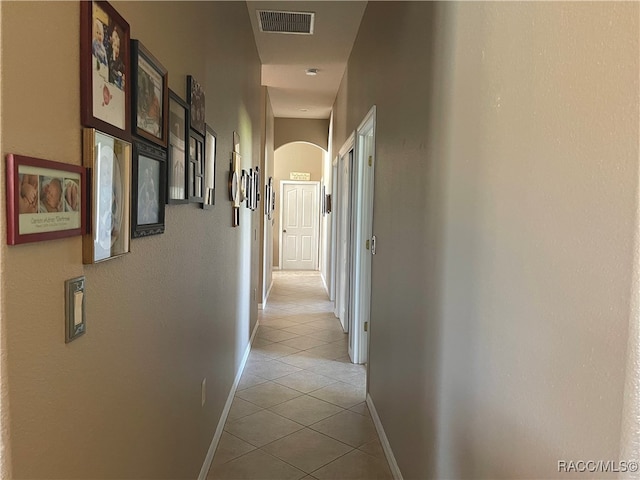 hall featuring light tile patterned flooring