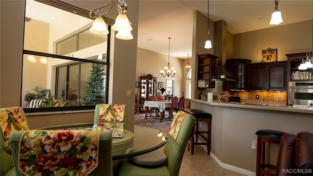 dining room featuring light tile patterned floors, sink, and an inviting chandelier