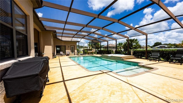 view of swimming pool featuring a lanai, a patio, and grilling area