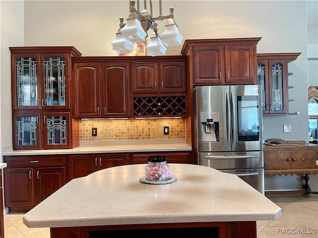 kitchen with stainless steel refrigerator with ice dispenser, backsplash, and light tile patterned flooring