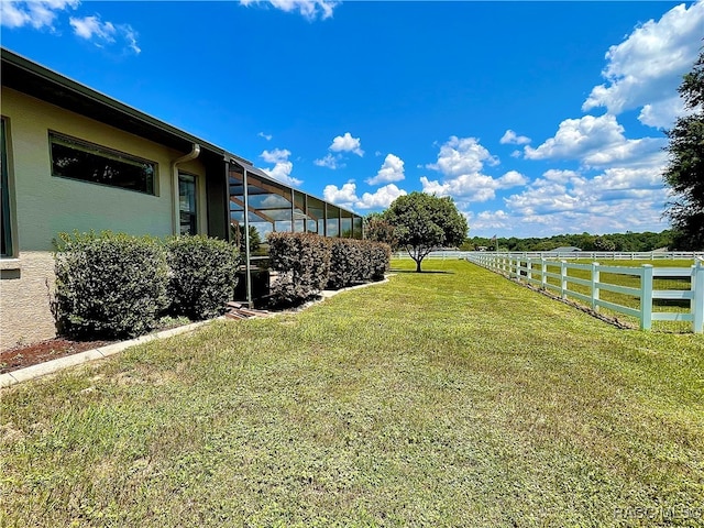 view of yard featuring glass enclosure