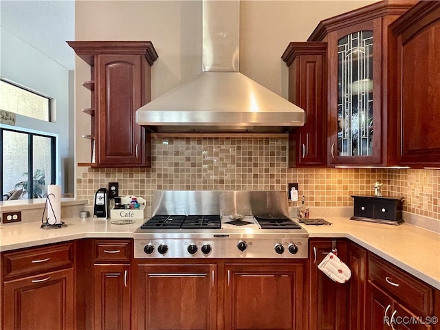 kitchen with backsplash, stainless steel gas cooktop, and wall chimney range hood