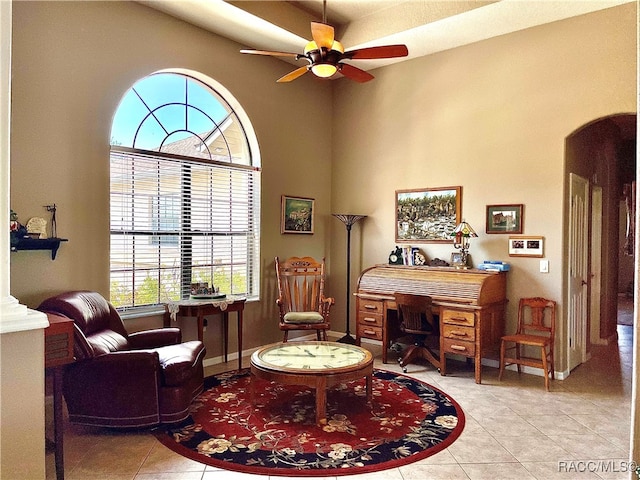 living area featuring ceiling fan and light tile patterned floors