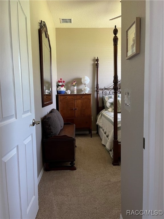 carpeted bedroom featuring a textured ceiling