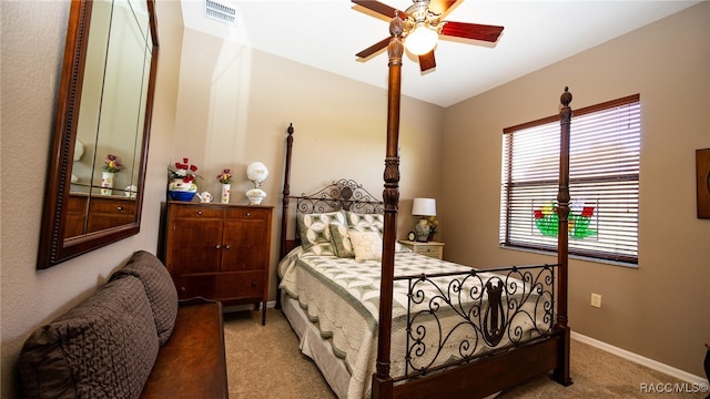 carpeted bedroom with ceiling fan and lofted ceiling