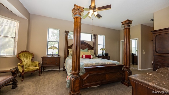 bedroom featuring light colored carpet, multiple windows, and ceiling fan