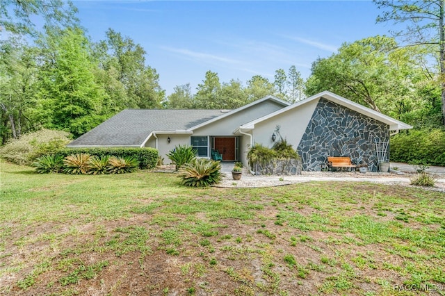 view of front of home with a front lawn and stucco siding