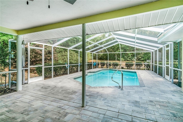 outdoor pool featuring a patio area and a lanai