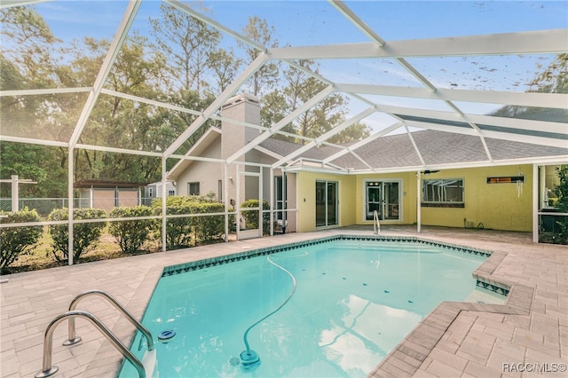 outdoor pool with a patio and a lanai