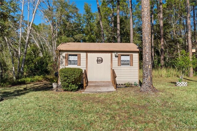 view of outbuilding featuring a yard