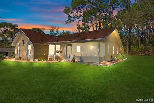 ranch-style home with a lawn