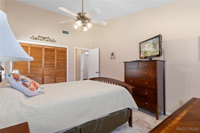 bedroom with ceiling fan and a closet