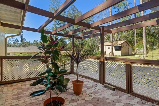 view of patio / terrace featuring a storage shed and a pergola