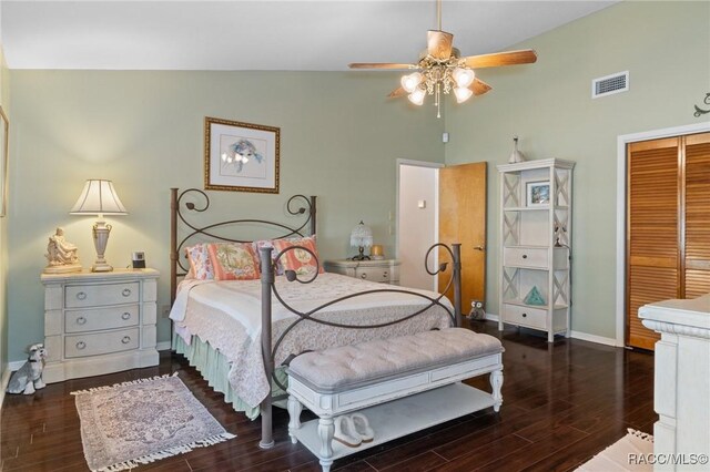 bedroom with ceiling fan, lofted ceiling, dark wood-type flooring, and a closet