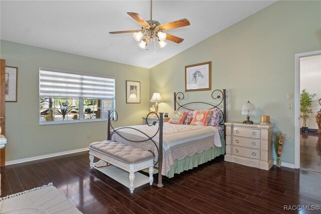 bedroom featuring ceiling fan, dark hardwood / wood-style flooring, and vaulted ceiling