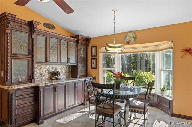 dining room featuring ceiling fan and vaulted ceiling