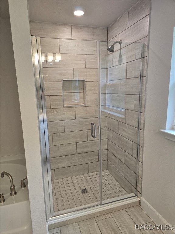 bathroom featuring a shower with shower door