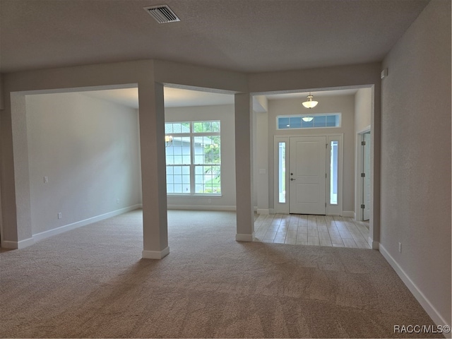 foyer entrance with light colored carpet