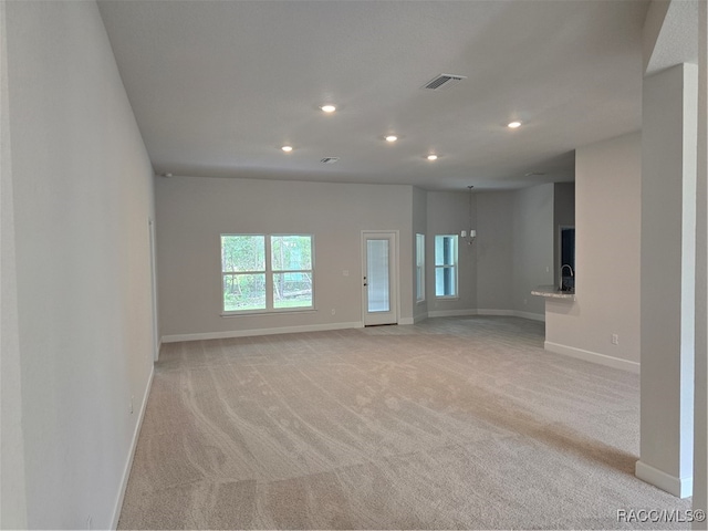 unfurnished living room with light carpet