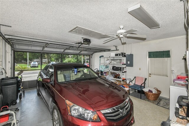 garage with ceiling fan, a garage door opener, and electric panel