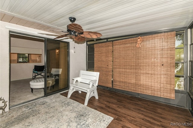 unfurnished sunroom with ceiling fan