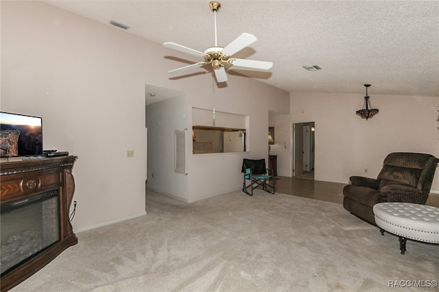 carpeted living room with a textured ceiling, ceiling fan, and lofted ceiling