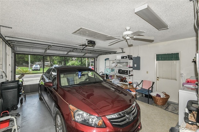 garage with electric panel, ceiling fan, and a garage door opener