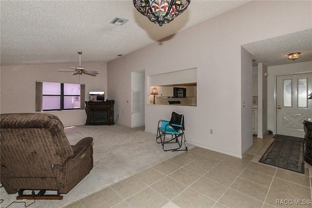 carpeted living room with a textured ceiling, ceiling fan, and lofted ceiling