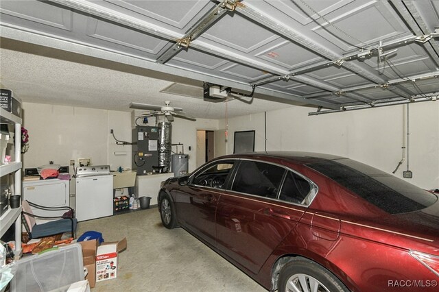 garage with electric water heater, a garage door opener, ceiling fan, separate washer and dryer, and heating unit