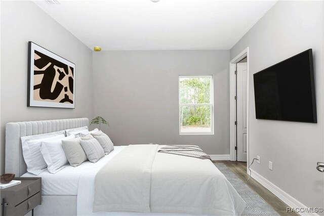 7024 N Fountainhead Dr, Citrus Springs, FL 34433 - bedroom featuring wood finished floors and baseboards