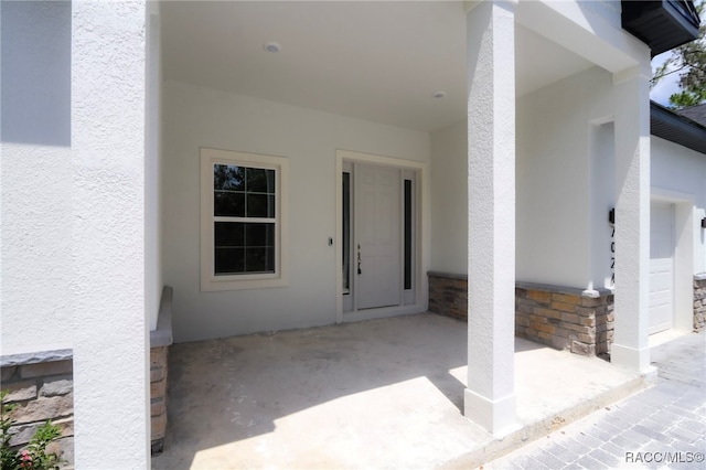 7024 N Fountainhead Dr, Citrus Springs, FL 34433 - property entrance featuring stucco siding, stone siding, and a patio