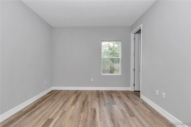 7024 N Fountainhead Dr, Citrus Springs, FL 34433 - empty room featuring light wood-style flooring and baseboards