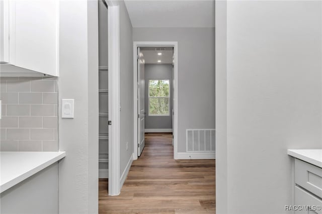 7024 N Fountainhead Dr, Citrus Springs, FL 34433 - corridor with light wood-style floors and baseboards