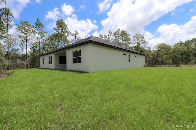 7024 N Fountainhead Dr, Citrus Springs, FL 34433 - back of property featuring stucco siding and a lawn