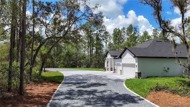 7024 N Fountainhead Dr, Citrus Springs, FL 34433 - view of home's exterior featuring gravel driveway, a shingled roof, a garage, and stucco siding