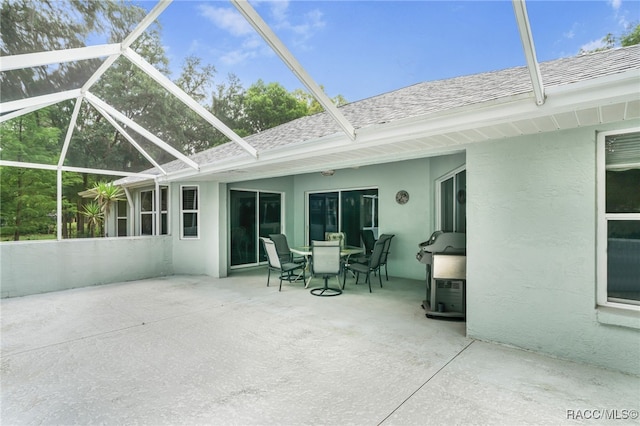 2617 E Newhaven St, Inverness, FL 34453 - back of house featuring a patio, roof with shingles, stucco siding, and glass enclosure